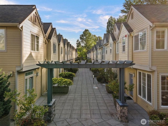 surrounding community with a pergola, a residential view, and a patio area