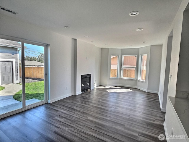 408-410 E 4th St, Warden, WA 98857 - unfurnished living room featuring a glass covered fireplace, dark wood-style flooring, baseboards, and recessed lighting