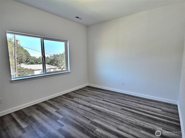 408-410 E 4th St, Warden, WA 98857 - spare room featuring plenty of natural light, baseboards, and dark wood-style flooring