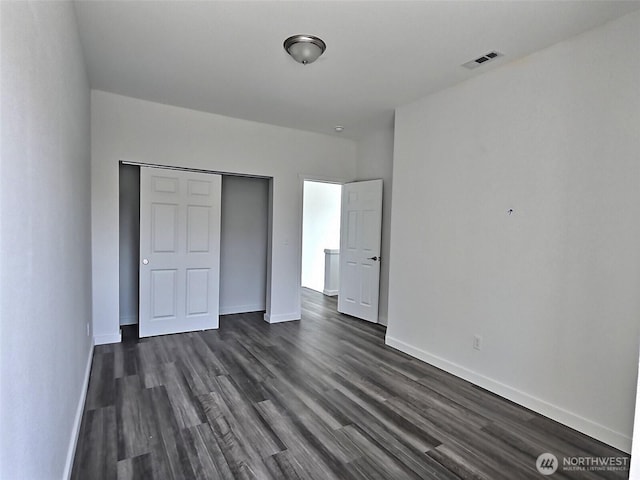 408-410 E 4th St, Warden, WA 98857 - unfurnished bedroom with dark wood finished floors, baseboards, and a closet
