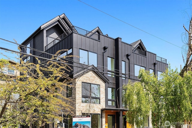 view of front of house featuring board and batten siding and a balcony