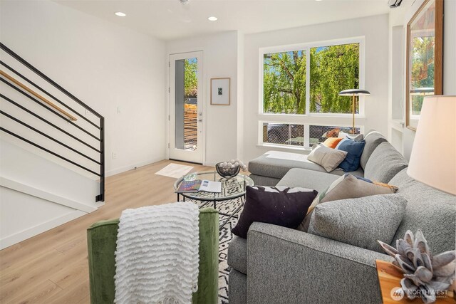 living room with wood finished floors, stairs, recessed lighting, and baseboards