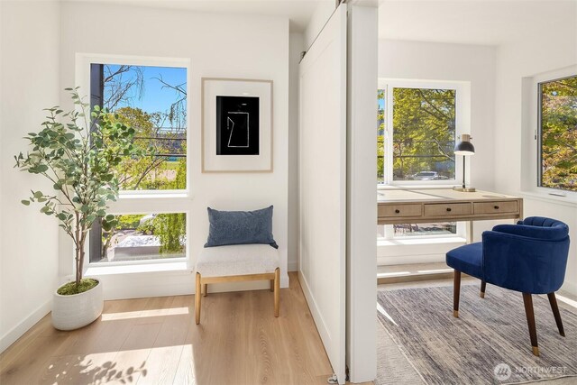 living area with wood finished floors and baseboards