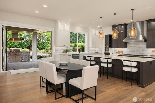 dining area with light wood-style floors and recessed lighting