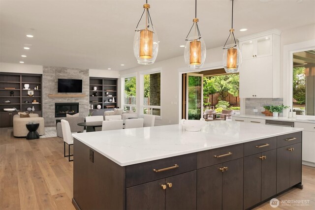 kitchen with white cabinets, light wood-type flooring, plenty of natural light, and recessed lighting