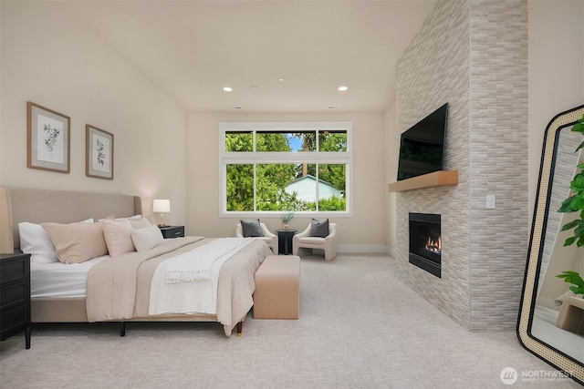 bedroom with a tile fireplace, carpet floors, and recessed lighting