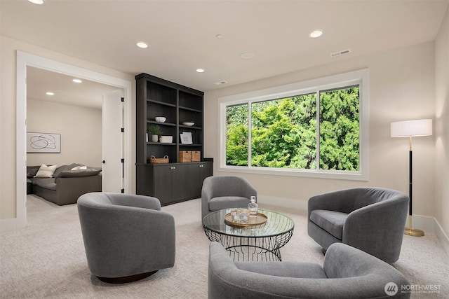 carpeted living area featuring recessed lighting and baseboards