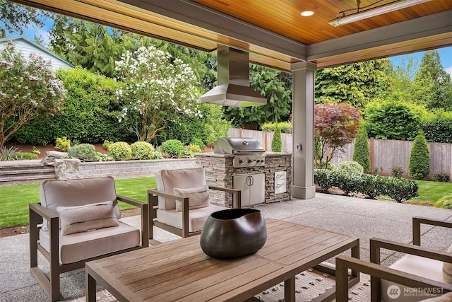 view of patio with grilling area, an outdoor kitchen, fence, outdoor lounge area, and ceiling fan