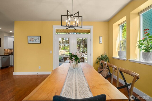 dining room with wood finished floors, baseboards, a chandelier, recessed lighting, and french doors