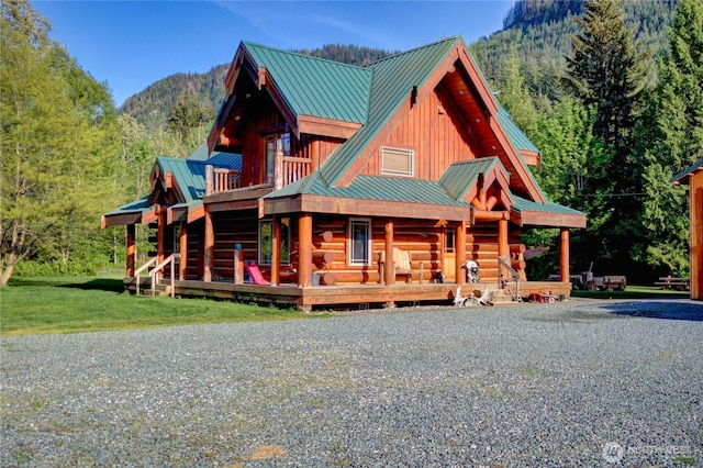 53932 Rockport Cascade Rd, Rockport, WA 98283 - log-style house with metal roof, board and batten siding, a wooded view, and a porch