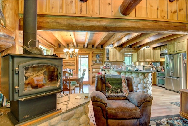 53932 Rockport Cascade Rd, Rockport, WA 98283 - living area featuring light wood-style floors, a chandelier, beamed ceiling, a wood stove, and wooden ceiling