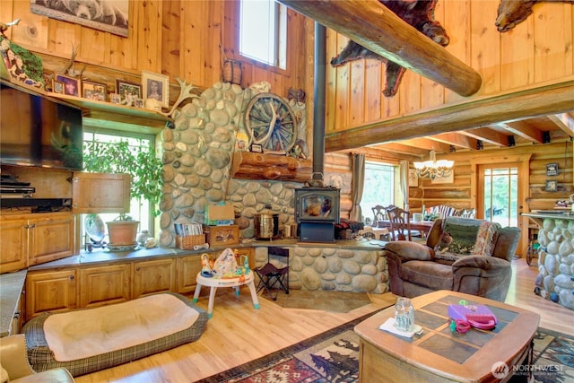 53932 Rockport Cascade Rd, Rockport, WA 98283 - living area featuring rustic walls, wood finished floors, healthy amount of natural light, a wood stove, and a high ceiling
