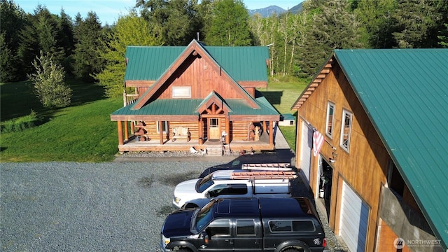 53932 Rockport Cascade Rd, Rockport, WA 98283 - log cabin featuring metal roof, a porch, a wooded view, and a front lawn