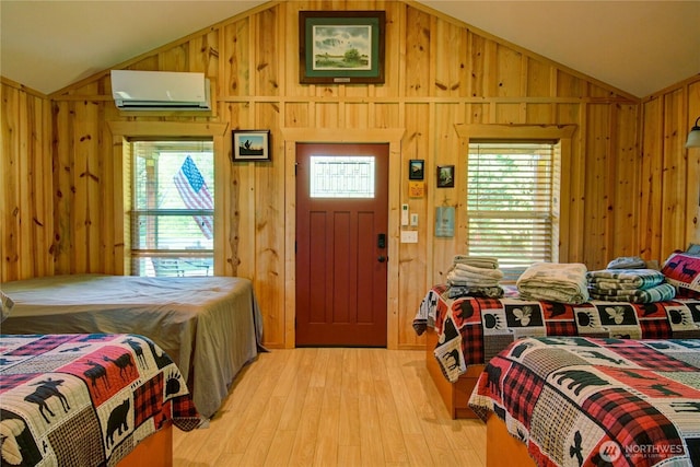 53932 Rockport Cascade Rd, Rockport, WA 98283 - bedroom featuring a wall mounted air conditioner, lofted ceiling, wooden walls, and light wood-type flooring
