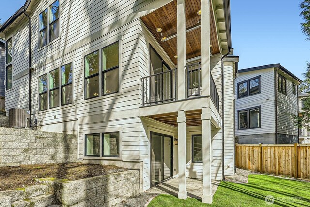 12105 NE 105th St, Kirkland, WA 98033 - rear view of house with a balcony, fence, and cooling unit