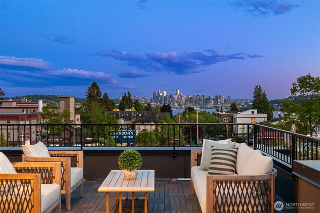 wooden terrace featuring outdoor lounge area and a view of skyline
