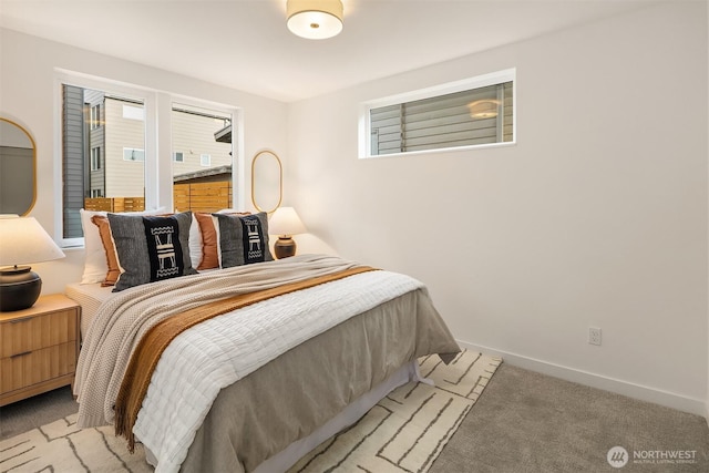 bedroom with light colored carpet and baseboards