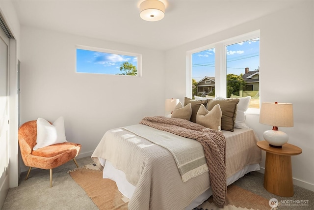 carpeted bedroom featuring baseboards