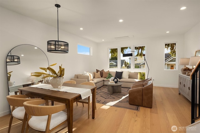 living room with light wood-style flooring, recessed lighting, and baseboards