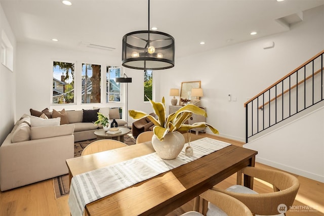 dining space with stairway, recessed lighting, light wood-style floors, and baseboards