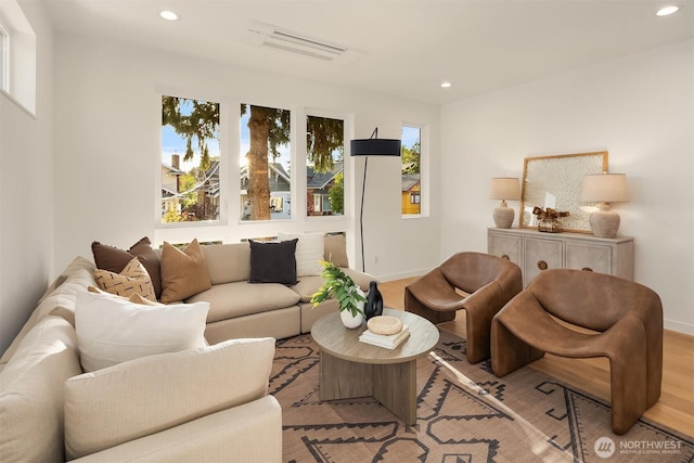living area with recessed lighting, baseboards, and wood finished floors