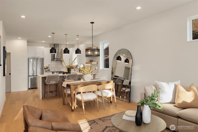 living room featuring light wood-style flooring and recessed lighting