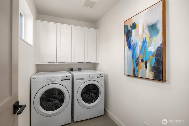 washroom with separate washer and dryer, cabinet space, baseboards, and tile patterned floors