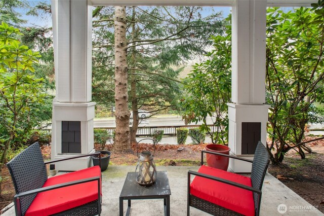 5589 Lakemont Blvd SE Unit 1702, Bellevue, WA 98006 - view of patio / terrace with a water view and an outdoor living space