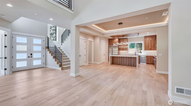 1593 213th Ct NE, Sammamish, WA 98074 - kitchen with brown cabinets, stainless steel dishwasher, open floor plan, light wood-type flooring, and light countertops