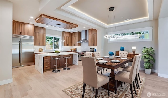 1593 213th Ct NE, Sammamish, WA 98074 - dining room with a raised ceiling and light wood-type flooring