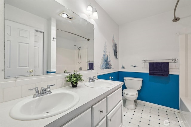 bathroom with toilet, tile patterned floors, double vanity, and bathing tub / shower combination