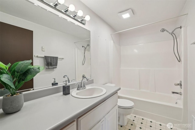 bathroom with toilet, vanity, and shower / washtub combination
