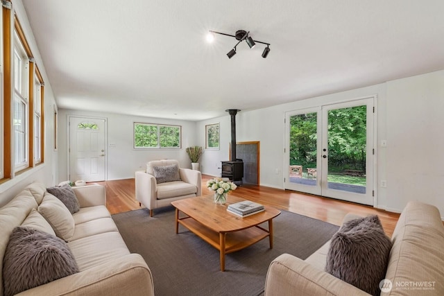 living room with a wood stove and wood finished floors