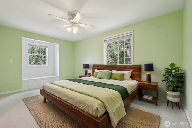 bedroom featuring carpet flooring, radiator, ceiling fan, and baseboards