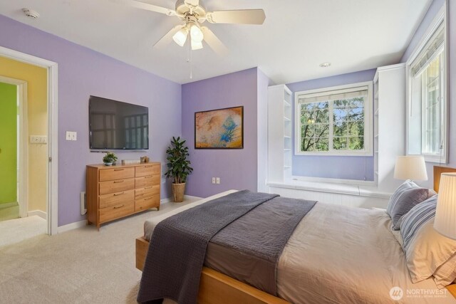 carpeted bedroom featuring ceiling fan and baseboards