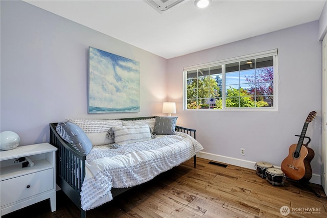 sitting room featuring hardwood / wood-style flooring and baseboards