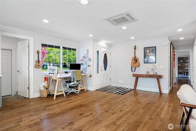 foyer featuring wood finished floors, recessed lighting, and baseboards