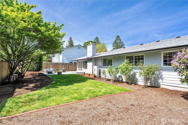 rear view of house with a chimney and a patio