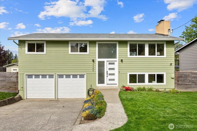 7344 125th Pl SE, Newcastle, WA 98056 - split foyer home with a chimney, concrete driveway, and a garage