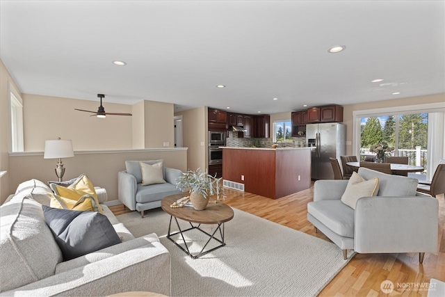 7344 125th Pl SE, Newcastle, WA 98056 - living area with light wood finished floors, recessed lighting, and a ceiling fan