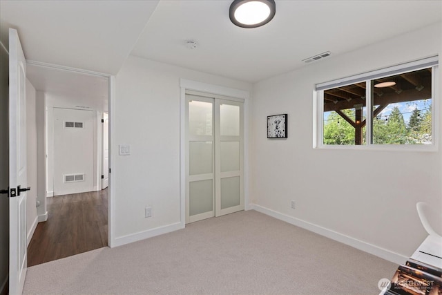 7344 125th Pl SE, Newcastle, WA 98056 - unfurnished bedroom featuring carpet flooring, baseboards, and a closet