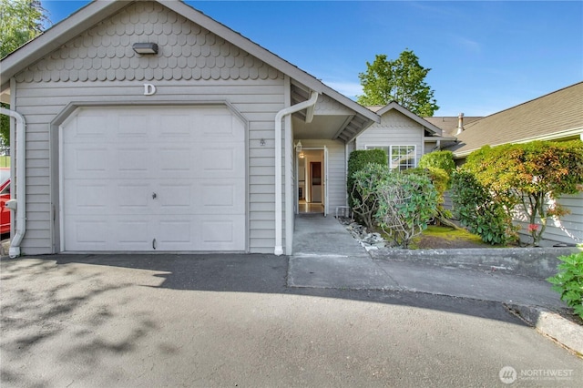 ranch-style home with driveway and an attached garage