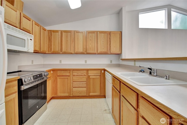 kitchen with white appliances, a sink, vaulted ceiling, and light countertops