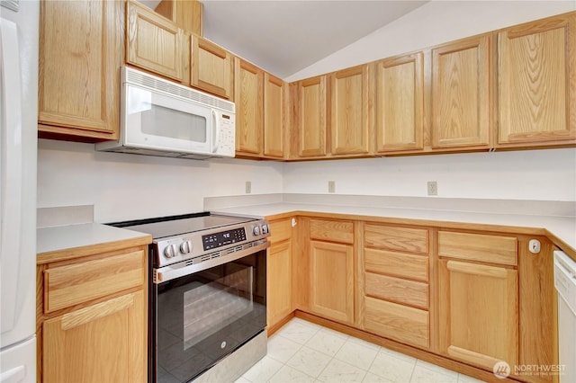 kitchen with white appliances, light brown cabinets, lofted ceiling, and light countertops