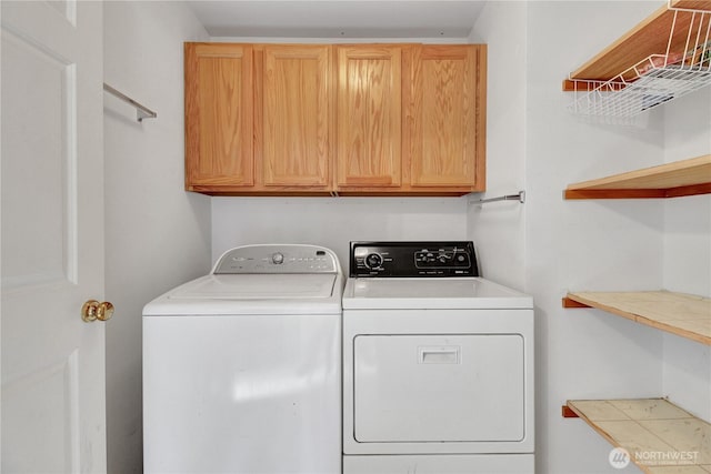 washroom with independent washer and dryer and cabinet space