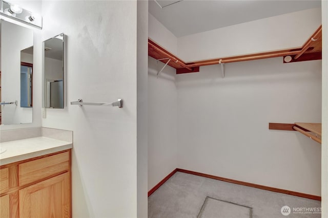 walk in closet featuring light colored carpet