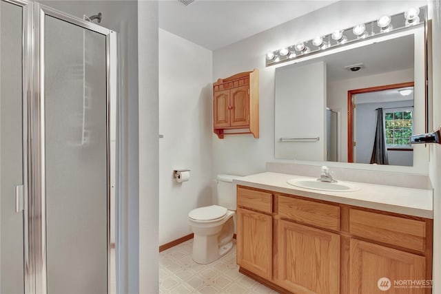 bathroom with a shower stall, tile patterned floors, toilet, and vanity