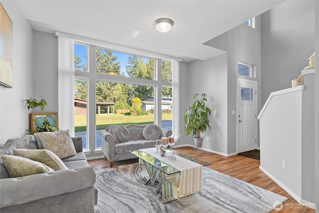 11511 SE 244th, Kent, WA 98030 - living area featuring a high ceiling, baseboards, and wood finished floors