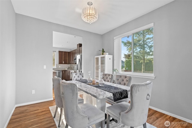 11511 SE 244th, Kent, WA 98030 - dining space with baseboards, a chandelier, and wood finished floors