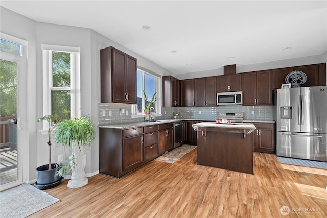 11511 SE 244th, Kent, WA 98030 - kitchen featuring stainless steel appliances, light wood-style flooring, light countertops, and decorative backsplash